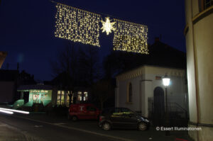 Weihnachtsbeleuchtung von Essert-Illuminationen mit LED-Lichterketten und Fiberglassternen als Straßenüberspannung in Polch